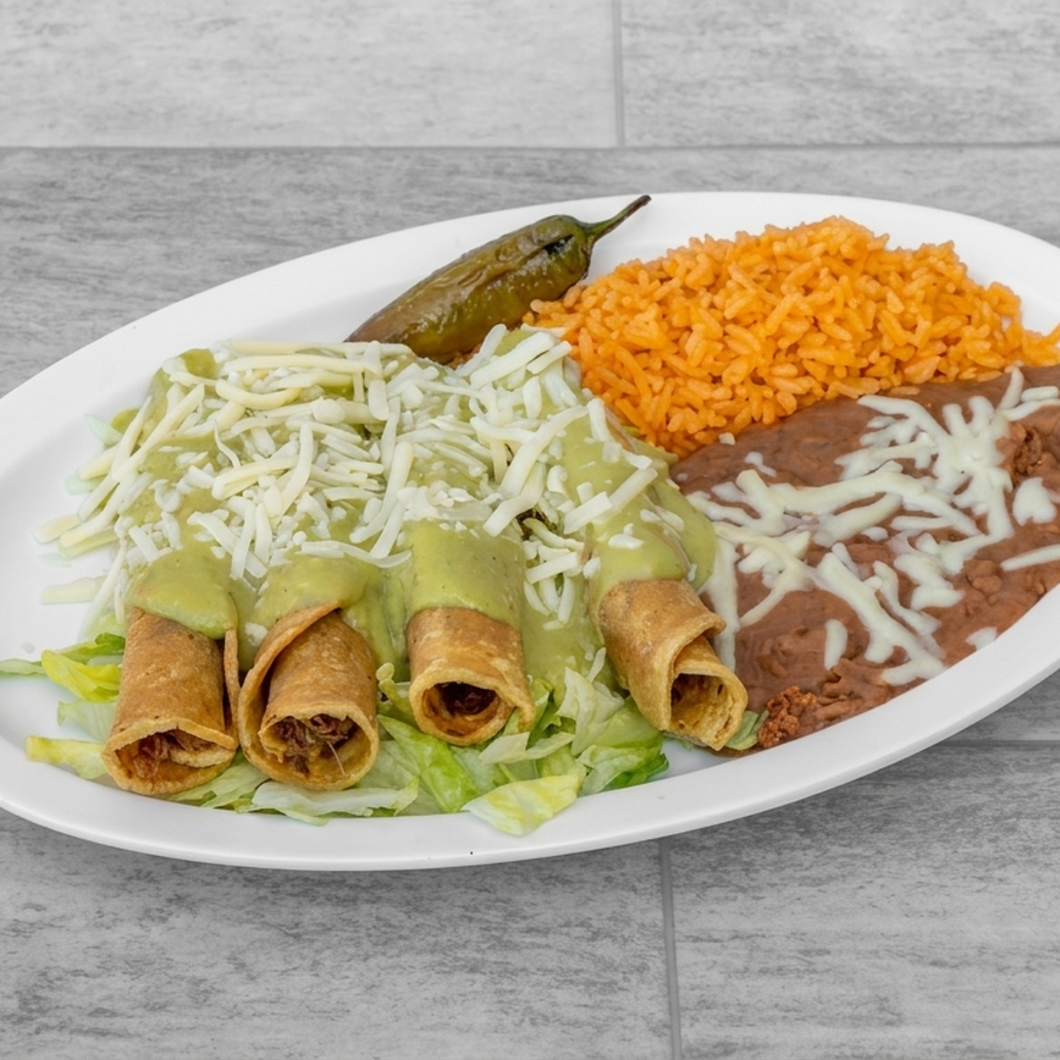 Mexican platter with rolled taquitos, green sauce, shredded cheese, refried beans, orange rice, and a roasted green chile.